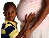 Boy Holding Mother's Pregnant Stomach - Pediatric and Cosmetic Dentists Keller, and Southlake TX - Donohue & Donohue, DDS