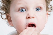 Child Holding Loose Tooth - Pediatric and Cosmetic Dentists Keller, and Southlake TX - Donohue & Donohue, DDS